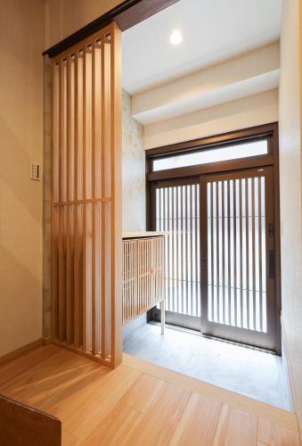 a pivot door in a room with a balcony at ZenKyoto in Kyoto