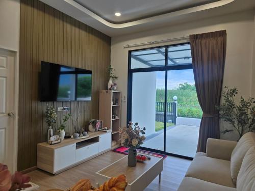 a living room with a large sliding glass door at Klong Loung House Airport transportation service in Pathum Thani