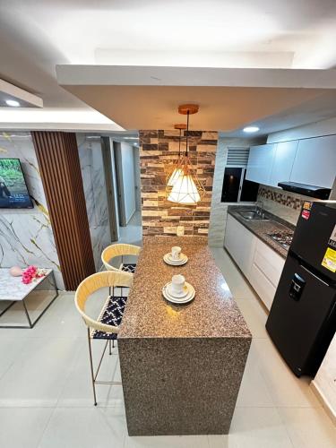 a kitchen with a island with a counter top at Refugio del Mar Barranquilla norte in Barranquilla