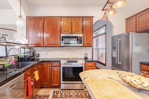 a kitchen with wooden cabinets and a wooden table at Nirav in Winston-Salem