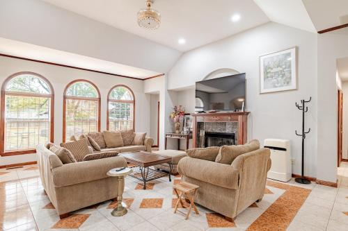 a living room with two couches and a fireplace at Nirav in Winston-Salem