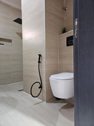 a bathroom with a toilet and a shower at Sapphire Suite in Abuja