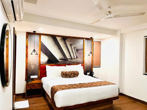 a bedroom with a large bed in a room at HOTEL SIGNATURE BANJARA HILLS Hyderabad in Hyderabad