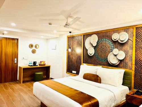 a bedroom with a large bed with hats on the wall at HOTEL SIGNATURE BANJARA HILLS Hyderabad in Hyderabad