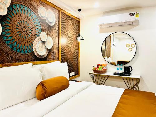a bedroom with a bed and a mirror at HOTEL SIGNATURE BANJARA HILLS Hyderabad in Hyderabad