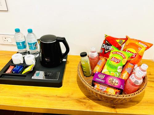 a basket of food and drinks sitting on a table at HOTEL SIGNATURE BANJARA HILLS Hyderabad in Hyderabad