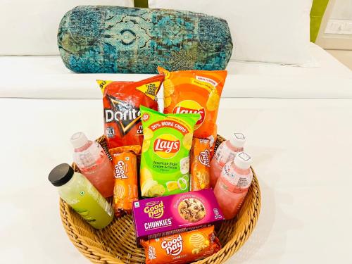 a basket filled with snacks and drinks on a counter at HOTEL SIGNATURE BANJARA HILLS Hyderabad in Hyderabad