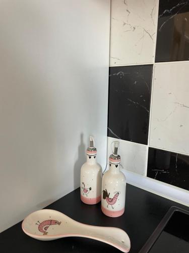 two bottles and a wooden spoon on a counter at Panorama Obrov in Bijelo Polje