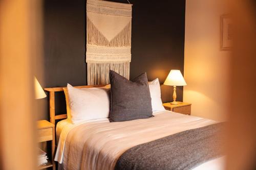 a bedroom with a bed with two pillows at Mandala Bruny Island in Alonnah