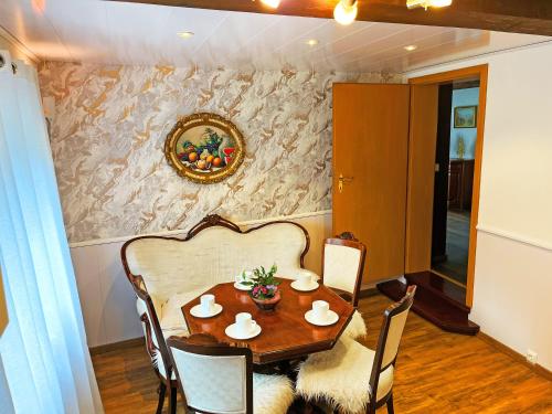 a dining room with a wooden table and chairs at Landhaus-Villa, Sauna, private Garten in Schleiden