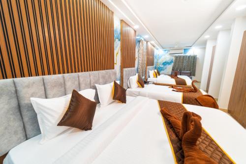 a row of beds in a room on a cruise ship at Mathi Residency in Chennai