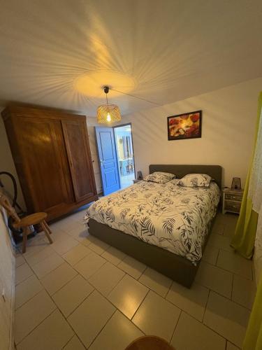 a bedroom with a bed and a blue door at Petite maison au coeur des Hautes-Alpes in Aspres-sur-Buëch