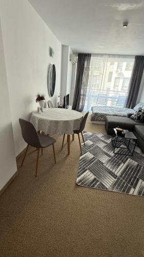 a living room with a table and chairs and a couch at Atlantis Resort in Burgas City