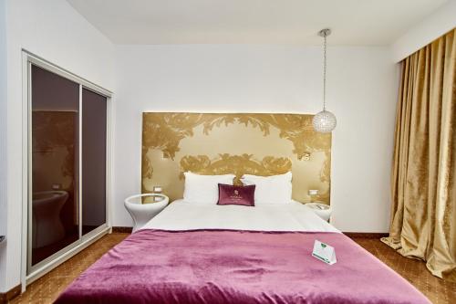 Cama o camas de una habitación en Hotel Panorama De Luxe