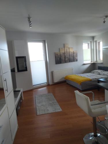 a bedroom with a bed and a desk and a chair at Apartamenty Centrum Studio Zagnańska in Kielce
