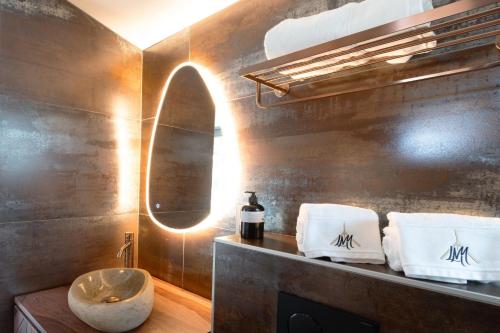 a bathroom with a sink and a mirror at La Maison d'Yvonne in Grand-Village-Plage