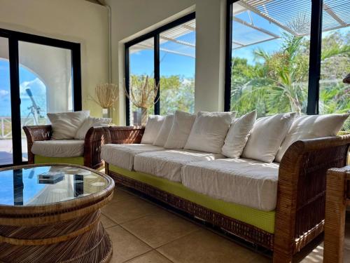 a living room with a couch and a glass table at Casa Nomad Luxe 2BR Villa, Ocean Views, Pool 