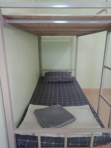 a bed in a room with a bunk bed in it at มังกรเลโฮสเทล Mangkonlay Hostel in Ban Khlong Pak