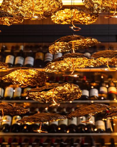 a room filled with lots of lights and wine bottles at Hôtel Les Roches Blanches Cassis in Cassis