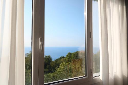 a window with a view of a forest at Hotel Gudamendi in Donostia-San Sebastián