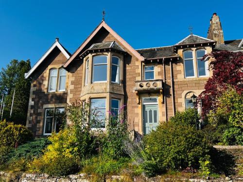 an old brick house on a sunny day at Dungora House in Crieff