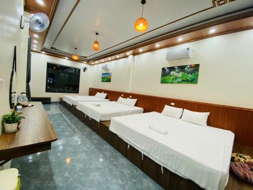 a room with a row of beds in it at Ninh Binh Royal Homestay in Ninh Binh