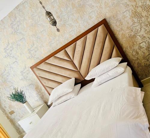 a bedroom with a bed with white sheets and pillows at The Bay in Dehiwala