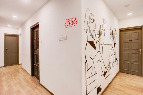 a hallway with a wall with a drawing on it at Townhouse Nagpur Junction Formerly Hotel Woodland in Nagpur