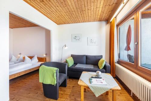 a living room with a couch and a bed at Ferienwohnungen Kehrwieder in Todtnauberg