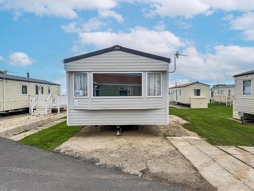 a tiny house sitting on the side of a road at Modern 6 Berth Caravan At Sand Le Mere Park, Yorkshire Ref 71002D in Tunstall