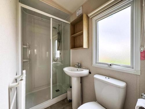 a bathroom with a toilet and a sink and a shower at Modern 6 Berth Caravan At Sand Le Mere Park, Yorkshire Ref 71002D in Tunstall