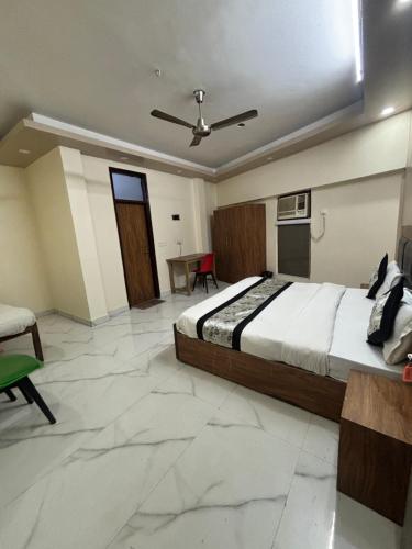 a bedroom with a bed and a table in it at Kerala Homes Near Nizamuddin in New Delhi