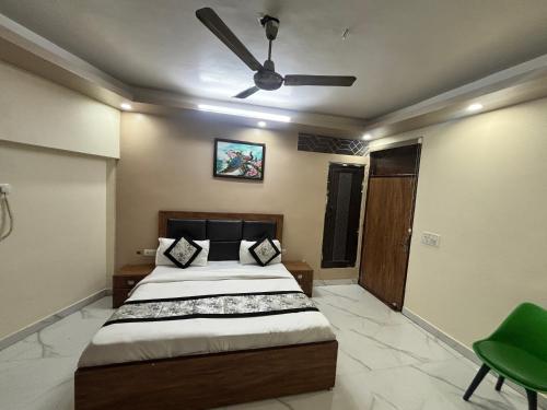 a bedroom with a bed and a ceiling fan at Kerala Homes Near Nizamuddin in New Delhi