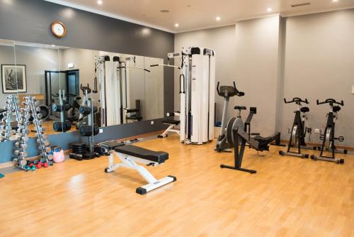 a gym with many exercise equipment in a room at Vila Gale Opera in Lisbon