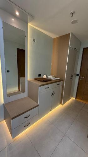 a bathroom with a counter with a sink and a mirror at HeavenStay Omaxe Hazratganj in Lucknow
