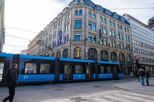 a blue bus parked in front of a building at Citybox Oslo in Oslo