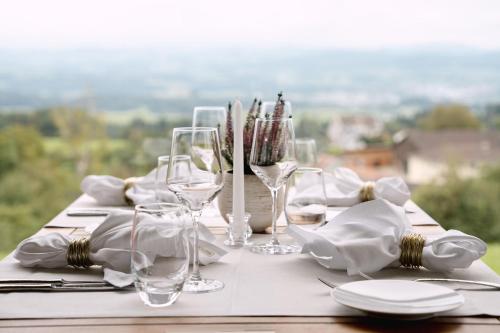a table with wine glasses and napkins on it at Hotel & Restaurant Nollen in Hosenruck