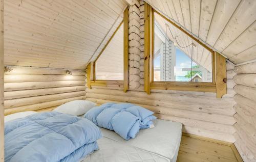 a bed in a wooden room with a window at Lovely Home In Tranekær in Tranekær