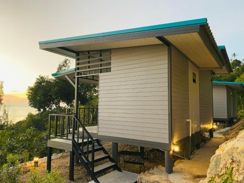 a tiny house with a staircase and a roof at Ananda Experiences in Salad Beach