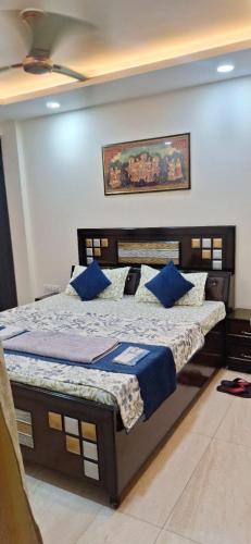 ジャランダールにある2 BHK Apartment, Jalandharの青い枕が付いた大きなベッドのある寝室