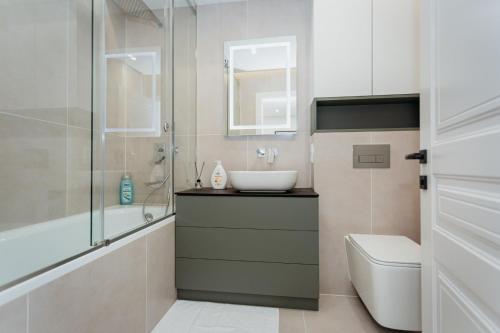 a bathroom with a sink and a toilet and a shower at Apartment lux in Chişinău