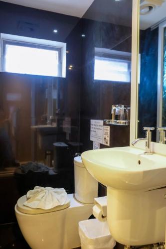 a bathroom with a sink and a toilet at Baanpoon Apartment in Chaweng