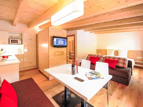 a living room with a white table and a couch at Studio Alpelux-2 by Interhome in Jerzens