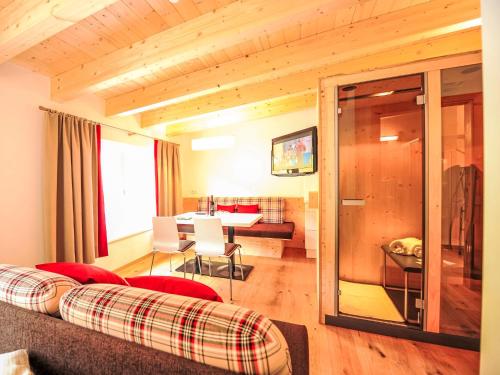 a living room with a couch and a table at Studio Alpelux-2 by Interhome in Jerzens