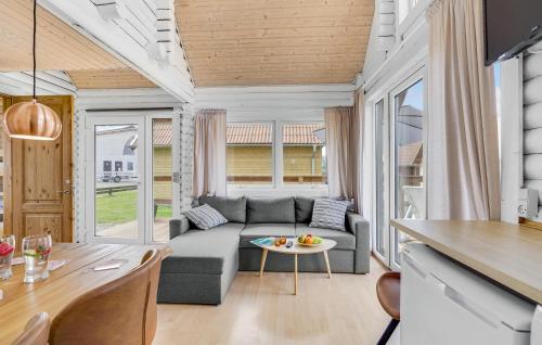 a living room with a couch and a table at Awesome Home In Tranekær in Tranekær