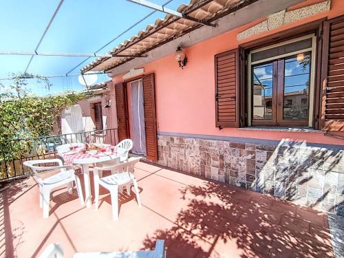 a patio with a table and chairs on it at Apartment Resi by Interhome in Tanaunella
