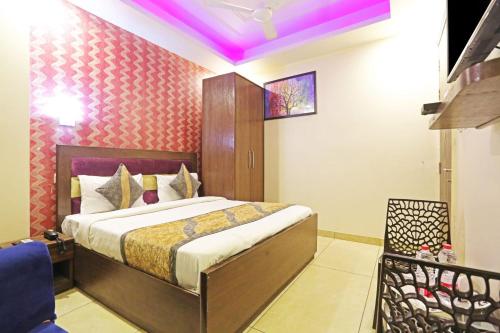 a bedroom with a bed with a purple ceiling at Hotel Iconic Ganga Ram hospital in New Delhi