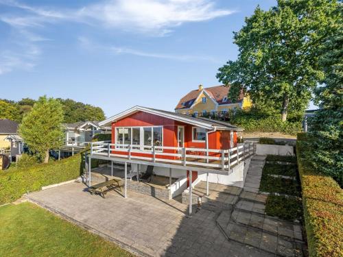 a home with a red and white house at Holiday Home Senni - 800m from the sea by Interhome in Rønsheved