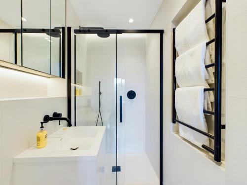 a bathroom with a sink and a shower at Be London - The St Pancras Residences in London