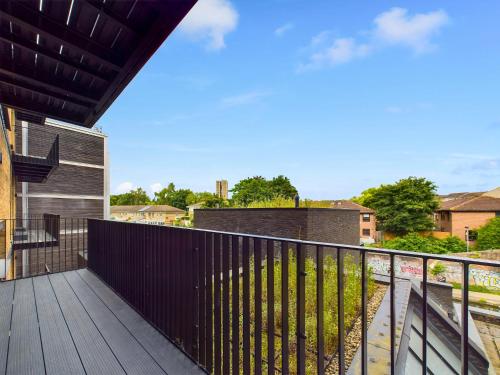 a balcony of a house with a wooden deck at Be London - The St Pancras Residences in London